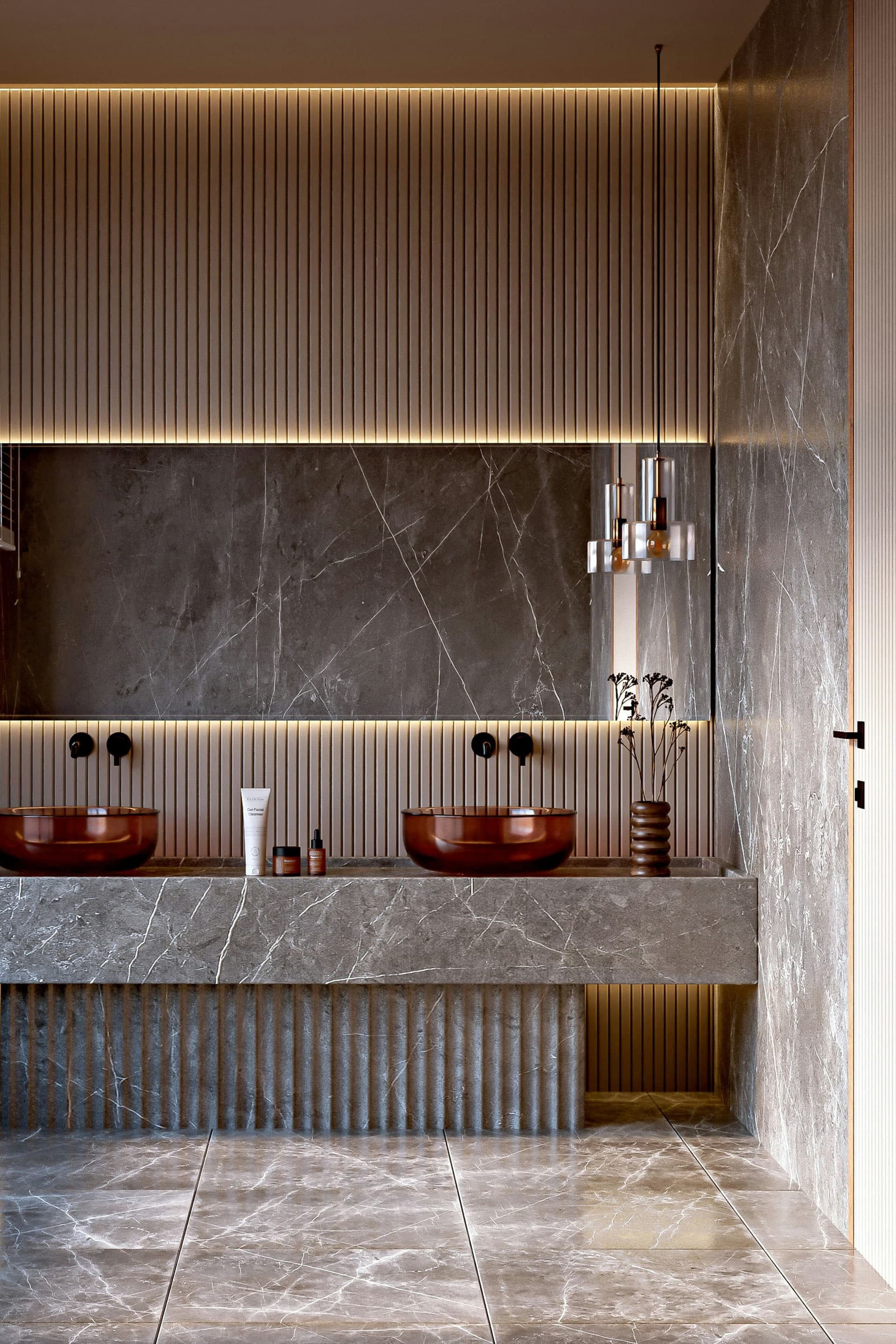Modern bathroom finished with dark tile and a white freestanding tub