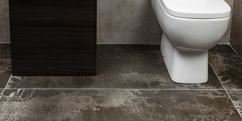 Floor tile being installed with mortar and spacers