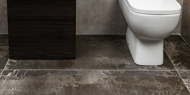 Tile installer working on a residential floor project