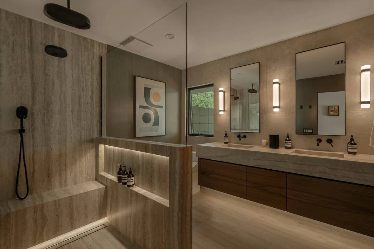 Marble-look shower tile with niche and black fixtures